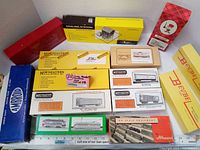 Overview photo showing all 14 boxed model train kits from multiple brands including Northeastern, Athearn, Campbell, Ambroid, Bevbel, and others.