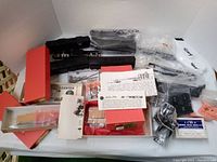 Lot laid out showing various train shells, parts in bags, red boxes, and instruction papers.