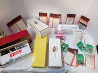 Wide view of the lot showing multiple boxed train model items, decal packets, and detailed parts systematically arranged.