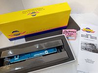 Image of the Genesis SD70 Conrail Quality scale model locomotive #2557 inside original foam packaging and box, also showing assembly instructions to the side.