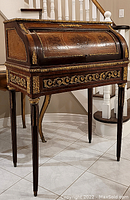 Full front-side view of the roll-top desk showing overall form, legs and tambour cylinder
