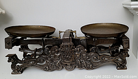 Front view showing full cast iron scale and two brass pans