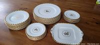 Overall view of all plates stacked separately on wooden table showing the entire set