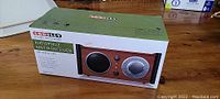 Boxed Crosley CR3108A audiophile AM/FM receiver radio with analog tuner picture on box.
