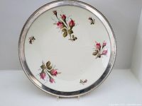 Top view of the 12-inch Rosenthal charger plate showing the sterling silver rim and hand-painted pink rose floral designs.