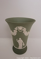 Front and side views of the green Wedgwood jasperware vase with white classical reliefs including figures and floral garlands.