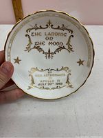 Front of the dish showing gold embossed writing commemorating the Apollo 11 moon landing July 20, 1969