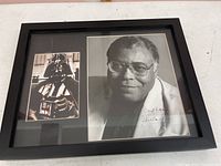 Framed display including a large black and white photograph of James Earl Jones with autograph and a smaller color photo of Darth Vader.