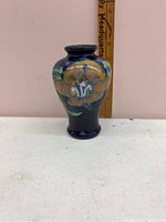 Front view of the small Japanese vase showing floral hand-painted design with ruler for scale.