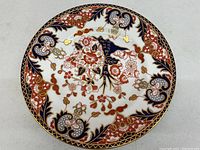 Top view of the Royal Crown Derby dinner plate showing detailed floral and gold pattern.