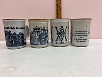 Front view of 4 Dunoon Ceramics Scottish pottery mugs with blue designs and beige background
