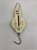 Front view of vintage Weigh-All 50 lb capacity hanging scale with visible weight measurements.