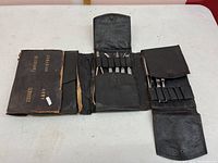 Folded black leather veterinary kit stamped on the front 'Canadian Army Veterinary Services'.