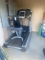 Treadmill deck, side rail and recumbent bike behind (bike not included)