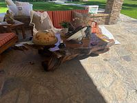 Full view of natural tree trunk coffee table with live-edge top and gnarled root base
