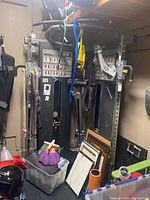 Full view of TuffStuff FTX Functional Trainer in storage with miscellaneous items in front