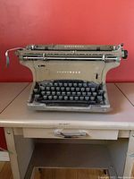 Clear front view of antique Underwood typewriter showing keyboard and typebars.