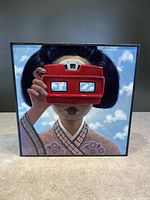 Front view of the square painting 'Clarity' depicting a woman holding a red View-Master viewer, showing sky and clouds reflected through the lenses.
