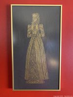Close-up image of the framed brass rubbing artwork showing Tudor royal woman in detailed dress