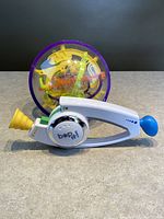 Spin Master Perplexus Original Maze ball and Hasbro Bop It handheld game shown side by side on a flat surface.