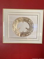 Frontal view of framed gold embossing print