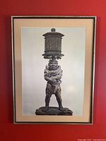 Framed black and white print of Ryutoki Lantern Bearer statue, showing full frontal view of the figure holding the lantern, against a plain background.