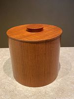 Front view of small Mid Century Modern teak ice bucket with lid on.