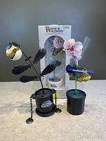 Front view of three Takara Rock'N Flowers dancing flower toys, including one in original box.