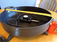 Side view measuring diameter of frying pan showing approximately 12 inches.