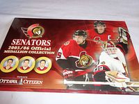 Closed front cover of the Ottawa Senators 2005/06 Official Medallion Collection folder showing branding and player images.
