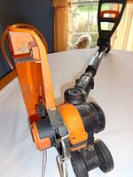 Close-up of the front of the WORX trimmer showing blade guard and head.