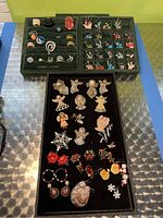 Overall jewelry collection including rings, earrings, and brooches arranged on jewelry trays.