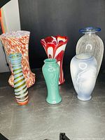 Front view of all six glass vases showing various colors and styles