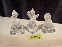 Photo showing three Goebel figurines: two cats and one dog, all mounted on clear glass bases and in good condition.