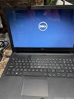 Show laptop screen powered on displaying Dell logo during boot up process