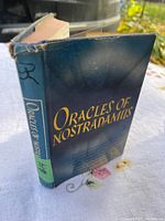 View of the front spine and cover of the book showing the title and original dust jacket with wear.