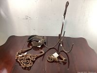 Overview of the antique metal decor items laid on a dark wood surface