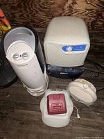 Four Honeywell branded appliances on wooden surface: humidifier, dehumidifier, vaporizer, heater.