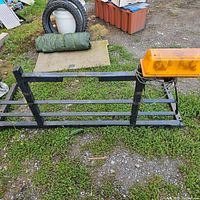 Photo of the back rack lying flat on ground showing overall structure and attached amber flashing light.