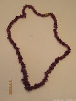Full view of the 15-inch antique garnet necklace laid out flat showing the complete length and clasp.