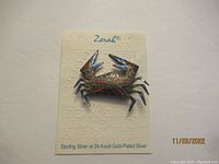 Zarah crab pin on its original card showing brand and material details