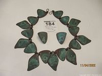 Copper jewelry set including hand made 20-inch necklace with multiple leaf-shaped patina copper pieces and matching earrings