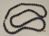 Full length view of the hematite bead necklace with visible clasp.