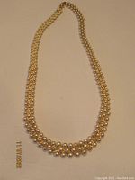 Full view of the 16" Napier marked faux pearl necklace interwoven with gold tone chain.