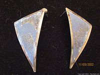 Pair of triangular sterling silver mesh earrings with silver borders, showing front view on black background.