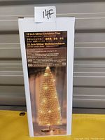 Box packaging of the 10 inch glitter Christmas tree showing product image and description in multiple languages including English, Japanese, and German.