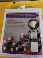 Box of 16ft Pinecone shaped Christmas string lights showing product details and picture of lights in use.