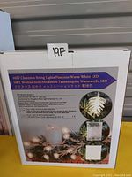 Box with label describing 16ft pinecone shaped Christmas string lights with warm white LED, battery powered.