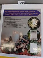 Photo of the product packaging showing details of the 16ft pinecone shaped warm white LED Christmas string lights