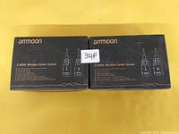 Two unopened boxes of Ammoon 2.4GHz wireless guitar systems, each displaying product features and an illustration of the transmitter and receiver.